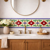 Mexican talavera floral relief border tile framing bathroom vanity wall in Spanish Colonial style