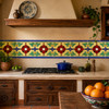 Mexican talavera floral relief border tile in a Spanish kitchen with terracotta and wood decor