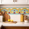 Mexican talavera scroll relief border tile decorative trim installed as kitchen backsplash border above colorful ceramic tiles