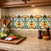 Mexican talavera yellow floral scroll relief tile installed as kitchen backsplash trim