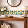 Mexican talavera yellow floral scroll relief tile applied along entryway wall trim