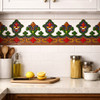 Mexican talavera relief border tile with heraldic floral motif installed as decorative kitchen backsplash border
