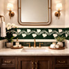 Mexican talavera heart vine relief border tile framing a bathroom vanity wall