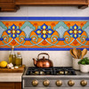 Mexican talavera floral scroll relief border tile installed as kitchen backsplash accent band