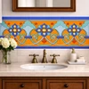 Mexican talavera floral scroll relief border tile above bathroom vanity wall detail