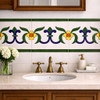 Mexican talavera fleur de lis relief border tile featured above bathroom vanity wall