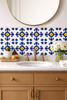 Cobalt cross motif talavera tile installed on a bathroom vanity wall with clean white grout and strong color