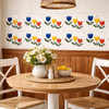 Talavera three tulip mexican tile featured on a dining area accent wall with relaxed artisanal style