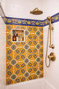 Talavera tile almond floral motif used in a bathroom shower creating a bold and traditional accent surface