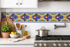 Talavera tile cross scroll botanical decorative border used as a kitchen backsplash accent with artisan style