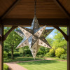 12-inch punched tin star lamp with colorful glass stones hanged in a gazebo during a daylight