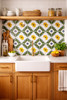 Yellow quatrefoil talavera tile used as a kitchen backsplash adding symmetry and classic Mexican style