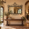 Wrought iron framed mirror – Spanish colonial design displayed in an old world style foyer