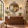 Wrought iron round mirror with scroll finials in a Spanish colonial bathroom interior