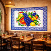 Colorful talavera fruit Mexican tile mural design on restaurant wall adding warm ambiance