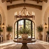 Black wrought iron circular candle chandelier displayed in a grand hacienda entryway