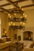Mexican hacienda iron chandelier in a living room with wood ceiling beams