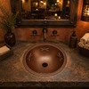 Dragonfly round copper bathroom sink showcased in a boutique restaurant washroom adding handcrafted copper character and charm