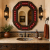 Octagonal tin mirror with red longhorn talavera tiles above a Spanish vanity area