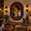 Decorating octagonal cobalt talavera tin mirror frame design inside a rustic Mexican restaurant