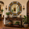 Octagonal talavera tile mirror accenting a warm Spanish Revival interior wall design