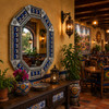 Octagonal decorative tin mirror with moon talavera tile frame enhancing a restaurant interior with traditional Mexican character