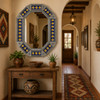 Handcrafted tin mirror with colorful sun tiles featured in a Mexican inspired hallway