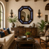Octagonal decorative tin mirror with blue talavera flower tiles mounted in a Mediterranean living room