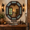 Octagonal decorative talavera tile mirror above a rustic hacienda style bathroom sink