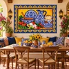 Mexican tile mural blue talavera tableware displayed in a bright breakfast nook with warm decor.