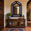 Handcrafted arch tin mirror featuring blue floral talavera tile accents entryway