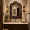 Handcrafted arch tin mirror with talavera moon tiles decorating a luxury powder room