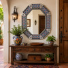Octagonal decorative tin mirror with floral talavera Spanish revival tiles decorating Mexican style entryway