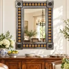 Cobalt Talavera sun mirror above a wood dining buffet with pottery and warm neutral walls