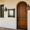 Mexican tin mirror with yellow sun Talavera tiles hung on the wall in the entry of a hacienda style house
