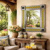 Blue Yellow Talavera Tile Mirror with floral geometric pattern and metal frame on covered veranda wall with garden reflection and rustic decor