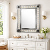 Talavera tile mirror with handcrafted metal frame and floral border in a bathroom