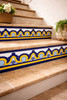 Talavera tile cobalt arch border with yellow accent featured on a stair riser with traditional character