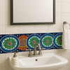Colonial green red talavera Mexican border tile framing a bathroom mirror with vibrant colonial-style colors