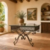 Spanish colonial style wrought iron table base with glass top in a Mediterranean interior