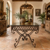 Spanish colonial style wrought iron table base with glass top in a hacienda dining room