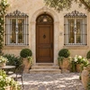Wrought iron door guard with curved crest and heart scrolls on a European courtyard doorway