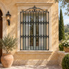 Renaissance wrought iron window guard with decorative crest on an Italian villa facade