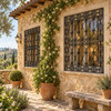 Wrought iron window guard with ornamental scrollwork design on a Tuscan country house