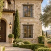 Wrought iron window guard with decorative crest on a historic stone villa facade