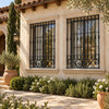 Andalusian house with black wrought iron window guards on a Mediterranean villa facade