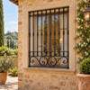 Andalusian house with black wrought iron window guards on a tuscan villa exterior