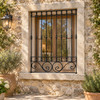 Andalusian house with black wrought iron window guards on a rustic stone house window