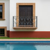 Wrought iron balcony railing with heart scroll motif installed on a Spanish Colonial style house in Southern California