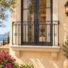 Wrought iron balcony railing with arched and twisted bars on a sunlit Mediterranean stucco facade